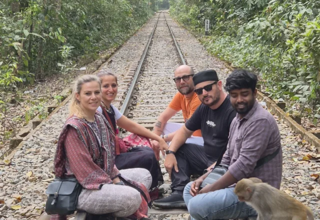 A group of tourist and a monkey in the railway