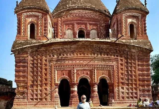 A tourist in front of Boro Govinda Temple