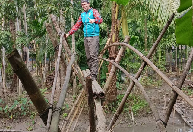 A tourist taking a shot on the bamboo bridge