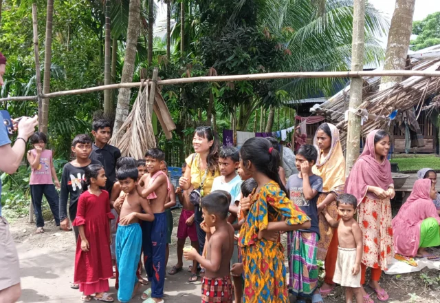 A tourist taking photo of local children