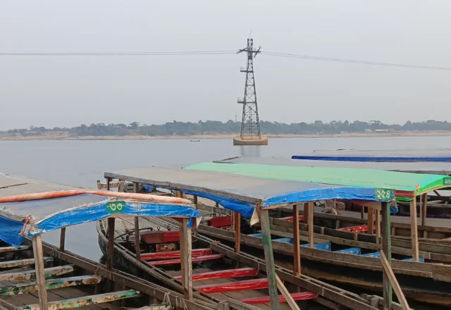 An electric pole in the middle of water
