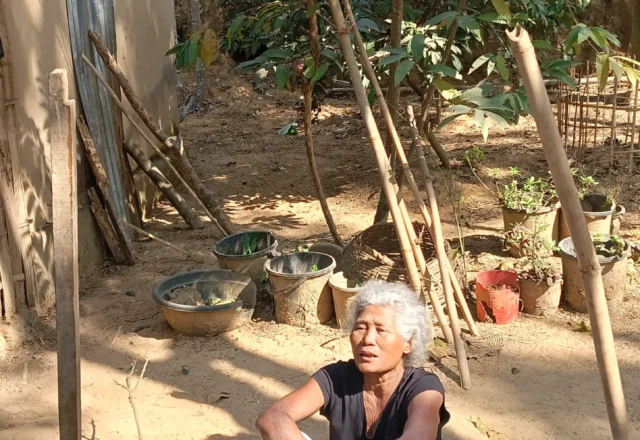 An exhausted local woman sitting on a colourful mat