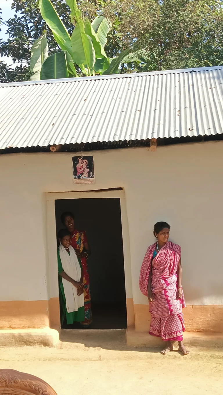 Beautiful smiling girls at the door of their house with their mother