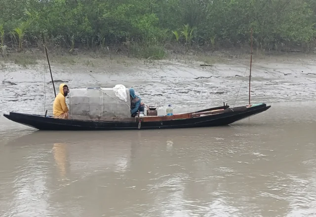 Fishermen with their boat in deep jungle of Sundarbans