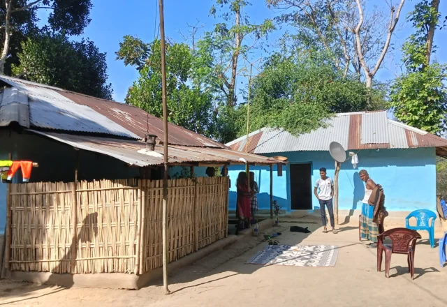 Locals standing at the yard of their house