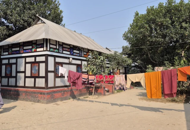 People drying clothes in front of their house