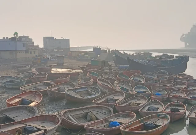 Small boats of fishermen gathered in the river banks