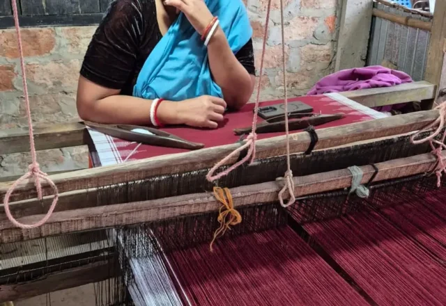 An woman from monipuri tribal community weaving traditional clothes