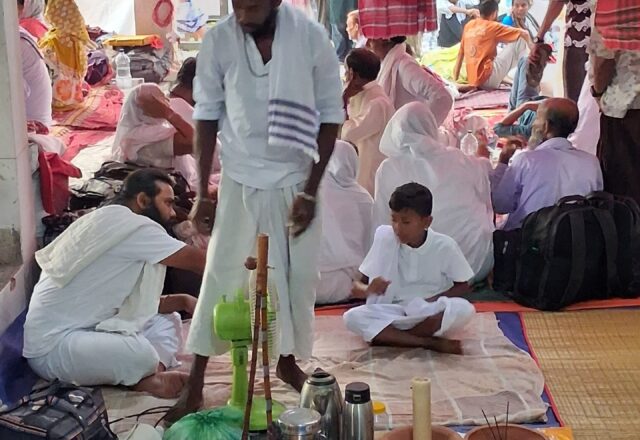 Baul devotees with offerings and incense in a festival tent at Lalon Akhra