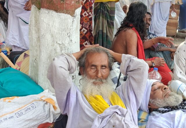 Baul elder resting with his hands behind his head at Lalon Akhra