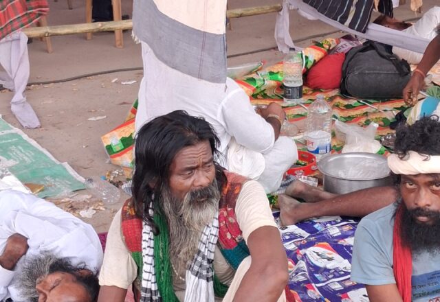 Baul fakir with long hair and a green scarf at the Lalon Mela