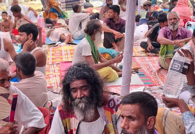 Bauls and devotees gathered on mats at Lalon Akhra during the festival