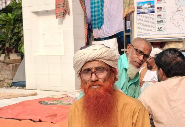 Devotee with a henna-red beard and white turban at the Lalon Mela