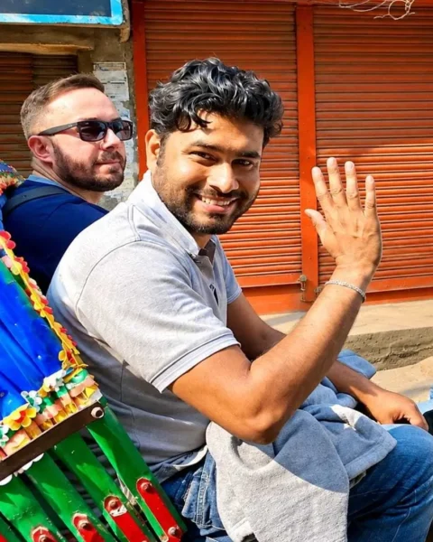Najib ferdous riding a rickshaw with a foreign tourust