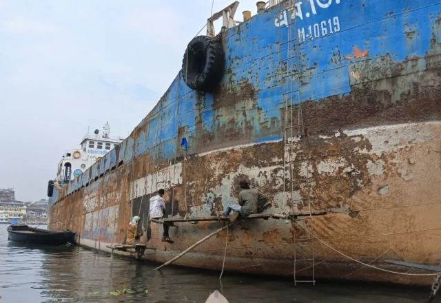 Workers are working on a junk ship to repair it